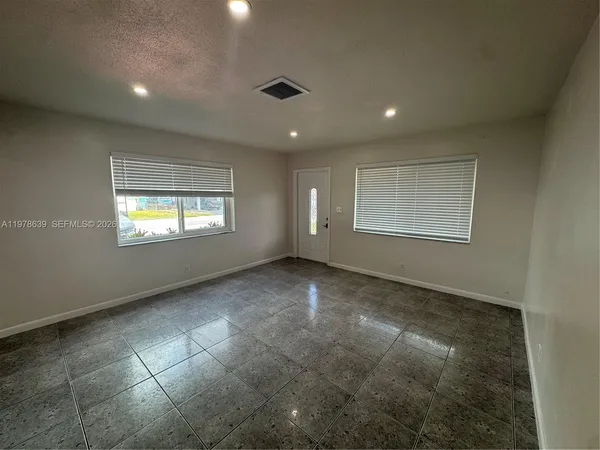 a view of an empty room with a window