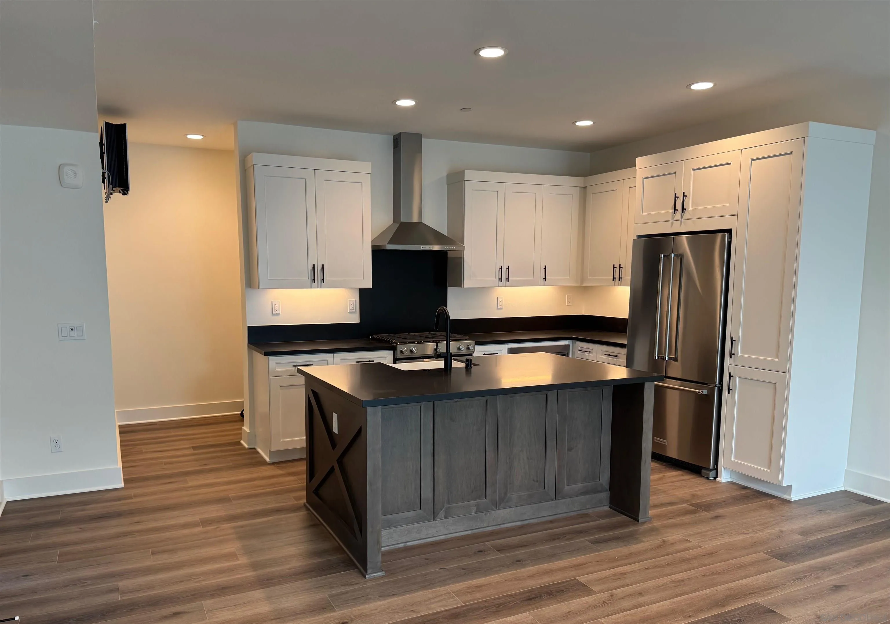 1107 Catania Court, Unit 205 Encinitas, CA 92024 - Photo 2 of 13 a kitchen with kitchen island a sink appliances and cabinets