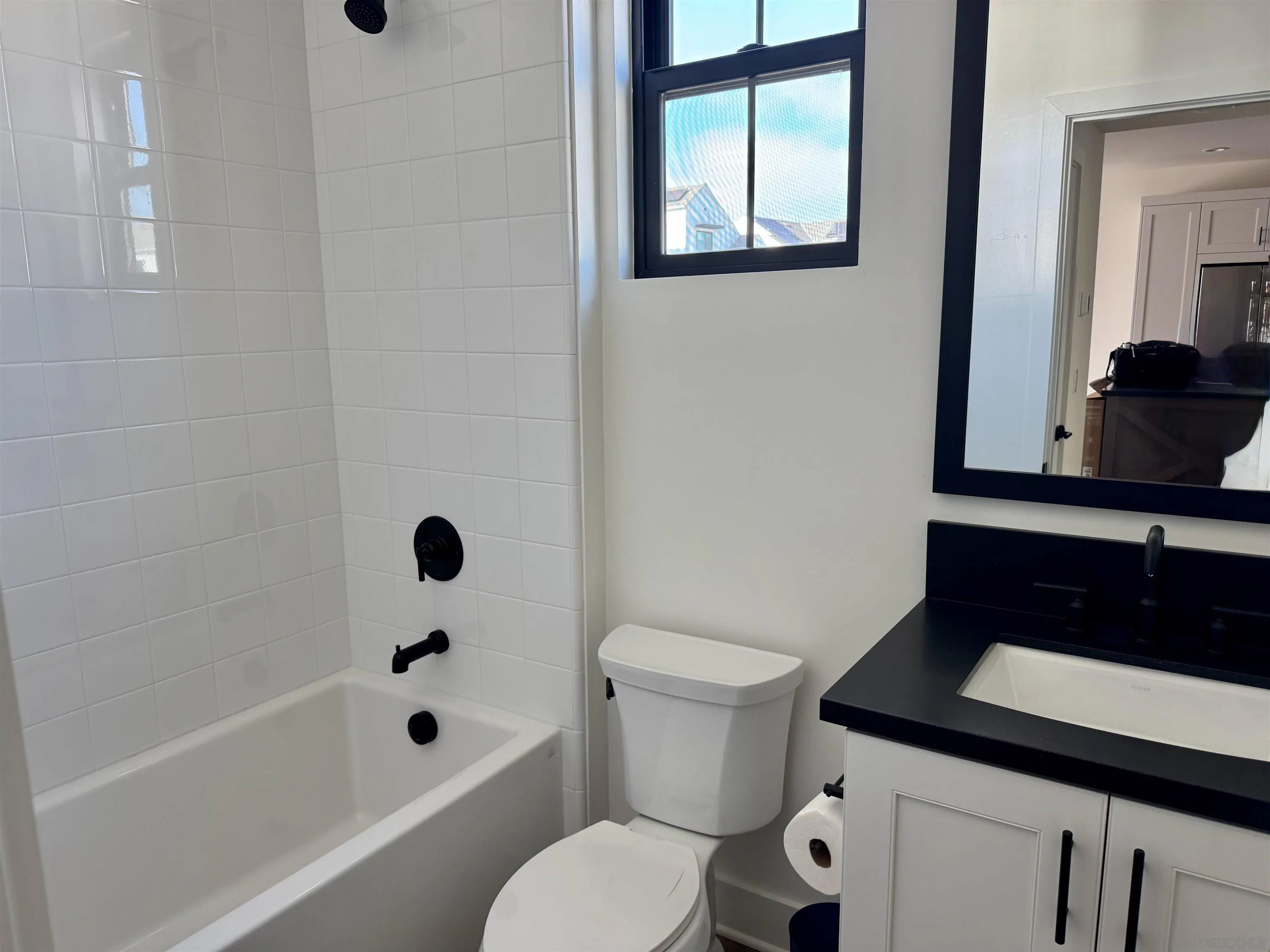 1107 Catania Court, Unit 205 Encinitas, CA 92024 - Photo 6 of 13 a bathroom with a sink a toilet and shower