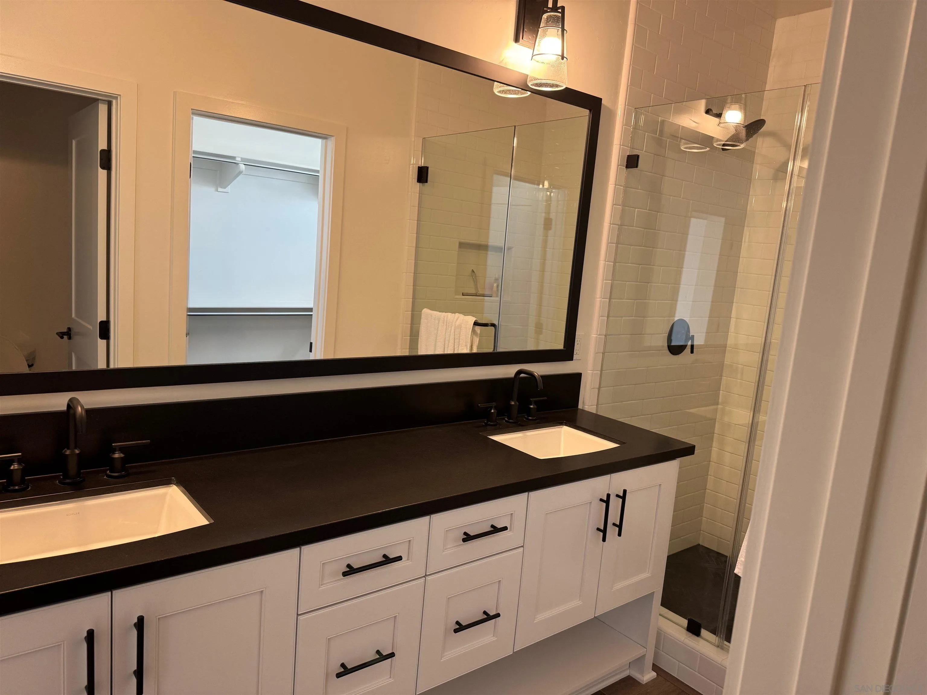 1107 Catania Court, Unit 205 Encinitas, CA 92024 - Photo 7 of 13 a bathroom with a sink and a mirror