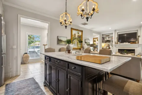 a dining room with a table chairs and a chandelier