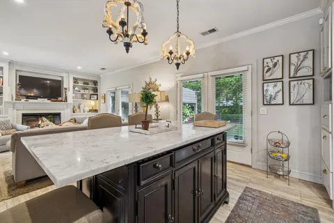a view of a dining room with furniture a couch and a chandelier