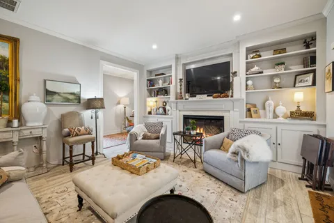 a living room with furniture fireplace and flat screen tv