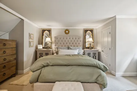 a bedroom with a large bed and a window