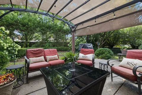 a view of backyard with outdoor seating and green space