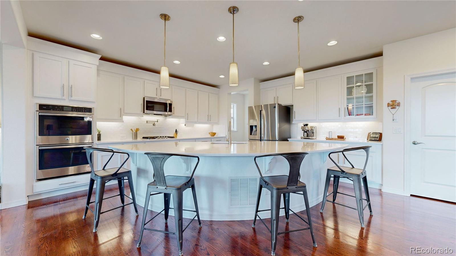 a large kitchen with kitchen island a dining table chairs and cabinets