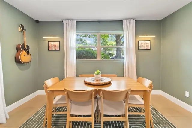 a dining room with furniture and window
