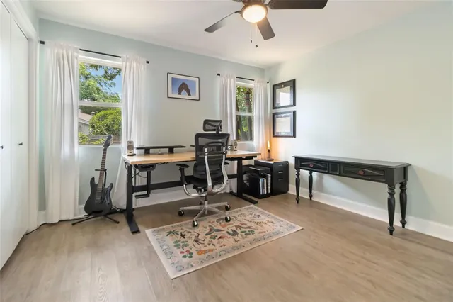 a view of a workspace with furniture and a window