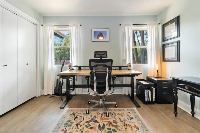 a view of a workspace with furniture and a window