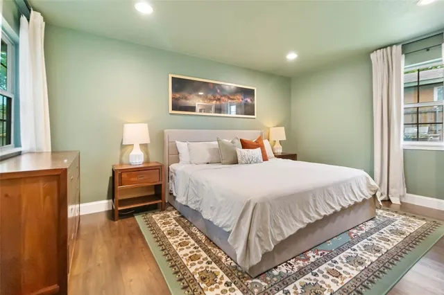 a bedroom with a bed and a painting on the wall