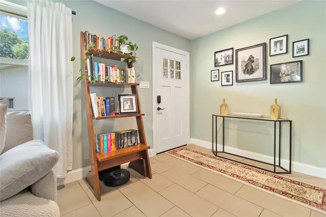 a living room with furniture and a book shelf