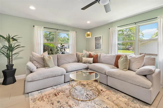 a living room with furniture and a large window