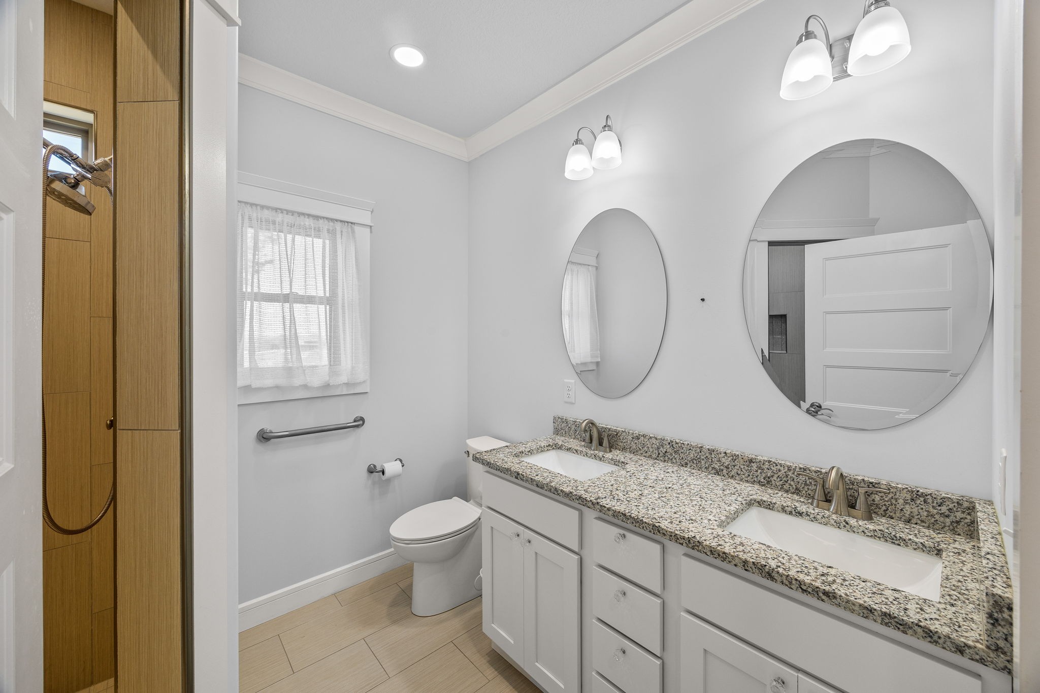 3261 Swan Ridge Road Celina, TN 38551 - Photo 14 of 28 a bathroom with a granite countertop toilet a sink and a mirror