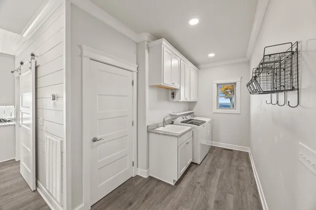 a kitchen with a sink a refrigerator and cabinets