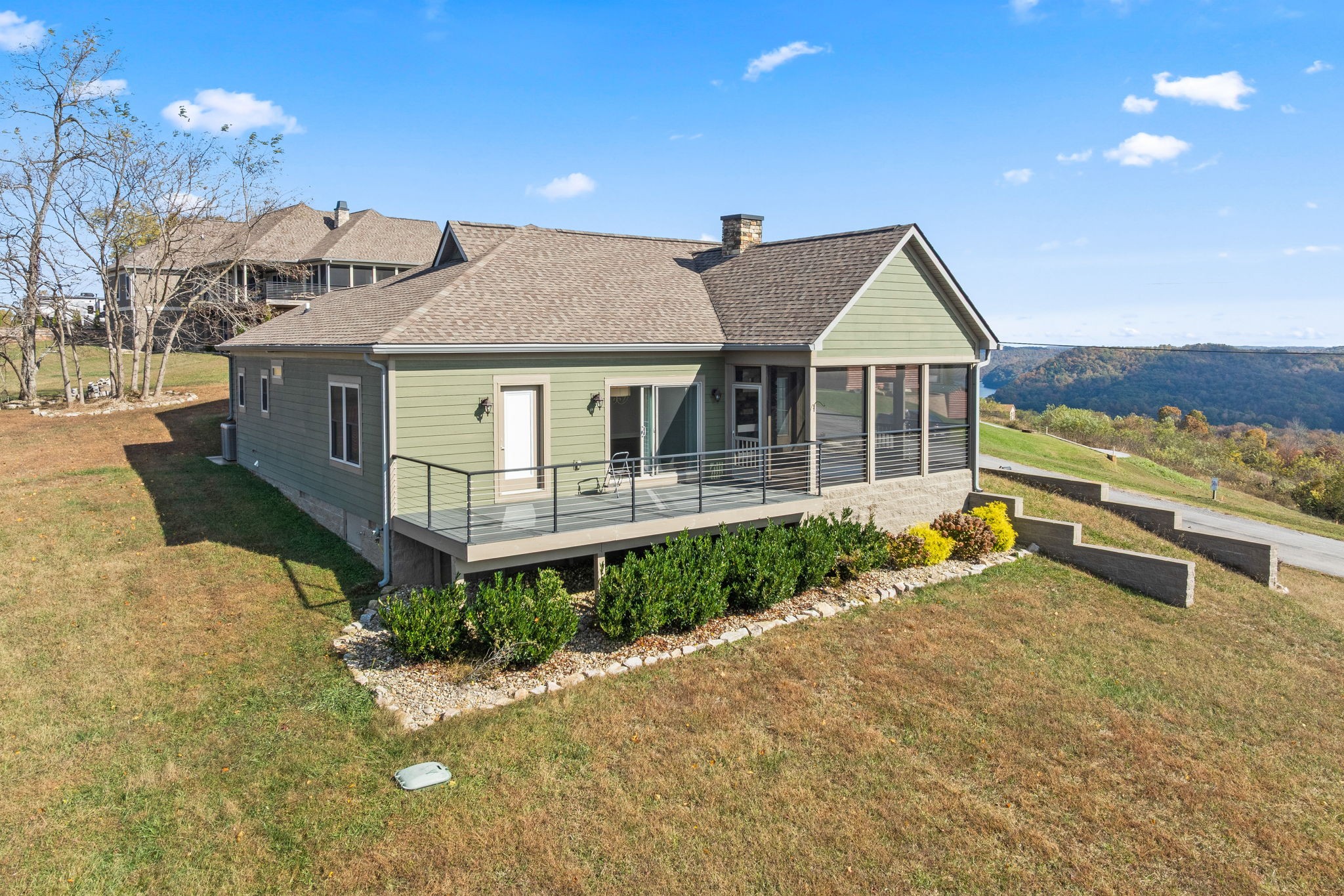 3261 Swan Ridge Road Celina, TN 38551 - Photo 20 of 28 a front view of a house with a garden and balcony