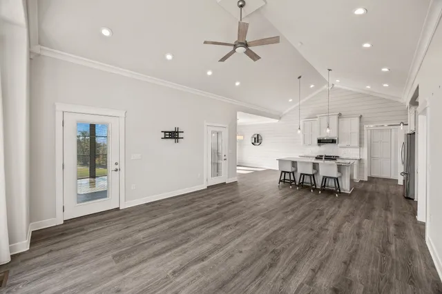 a large kitchen with a sink and breakfast area
