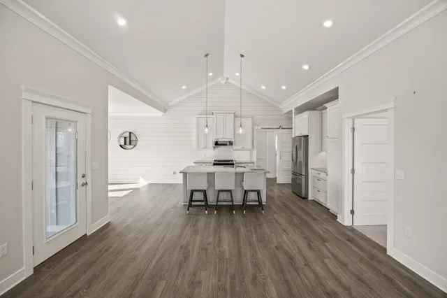 a dining room with furniture and wooden floor