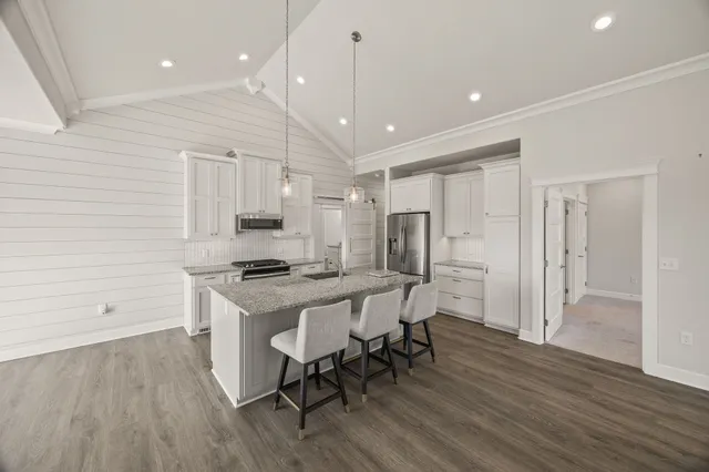 a kitchen with a table chairs refrigerator and microwave