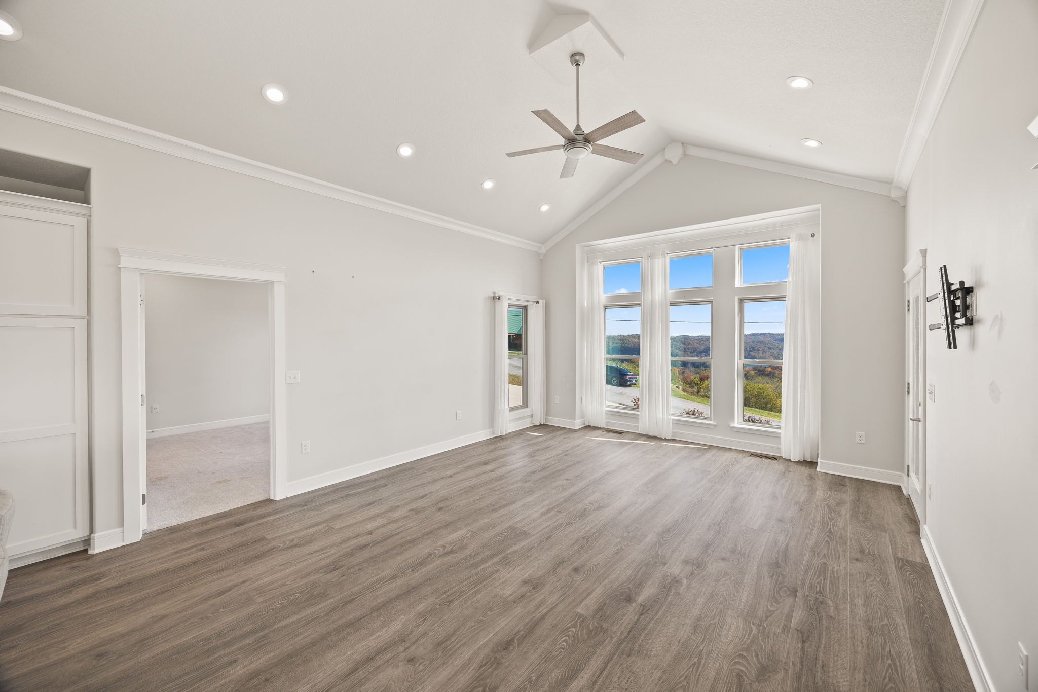 3261 Swan Ridge Road Celina, TN 38551 - Photo 5 of 28 an empty room with wooden floor fan and windows