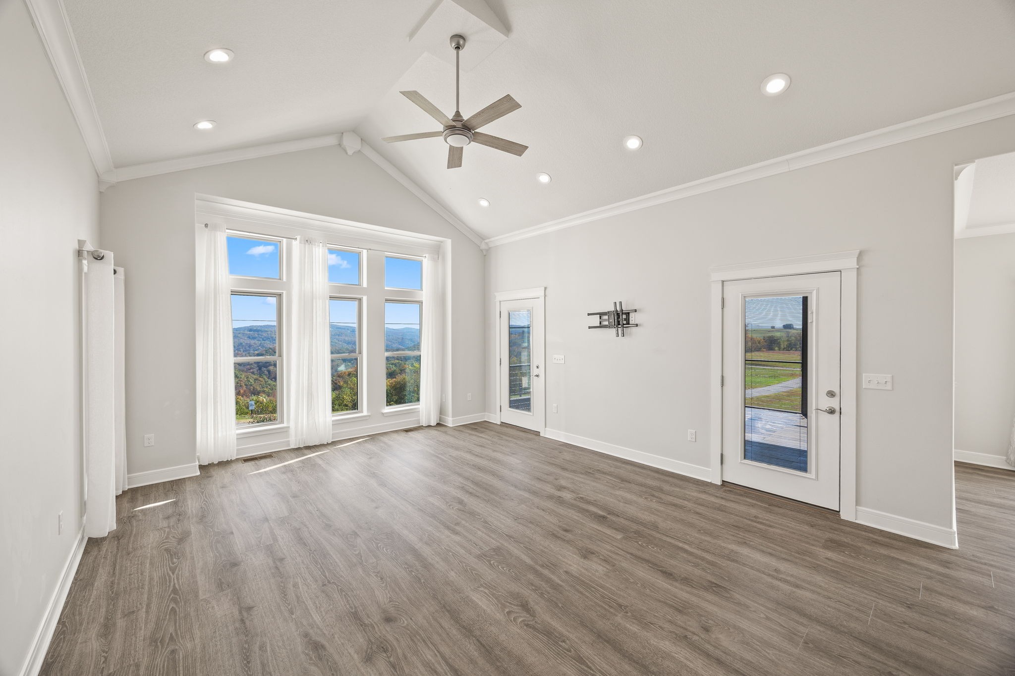 3261 Swan Ridge Road Celina, TN 38551 - Photo 6 of 28 a view of an empty room with wooden floor ceiling fan and window