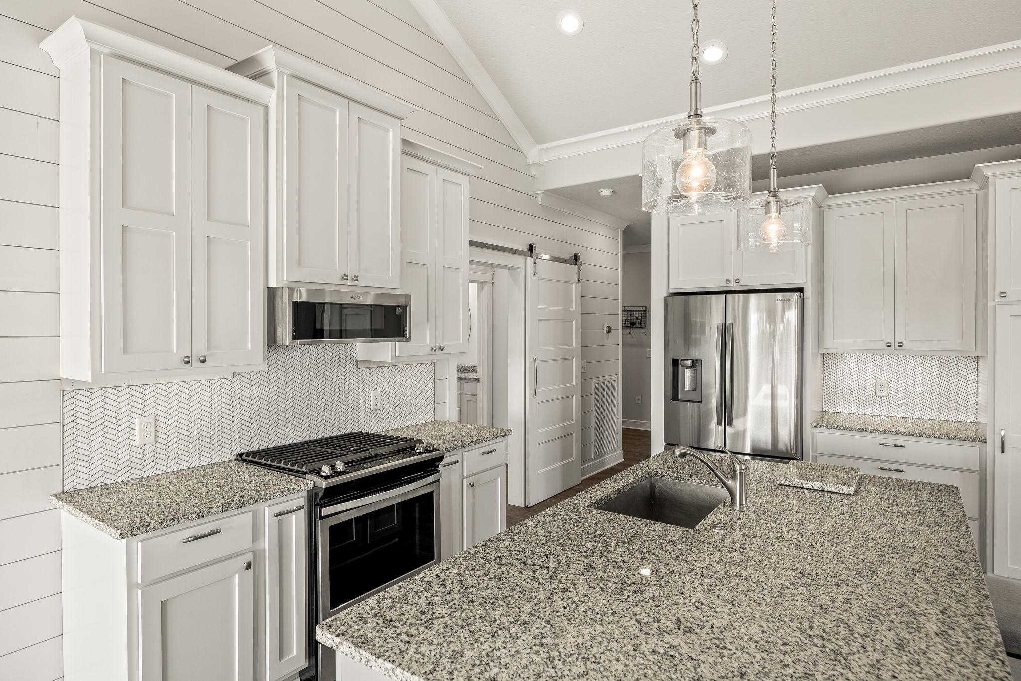 3261 Swan Ridge Road Celina, TN 38551 - Photo 8 of 28 a kitchen with stainless steel appliances granite countertop a stove a refrigerator and a sink with wooden floor