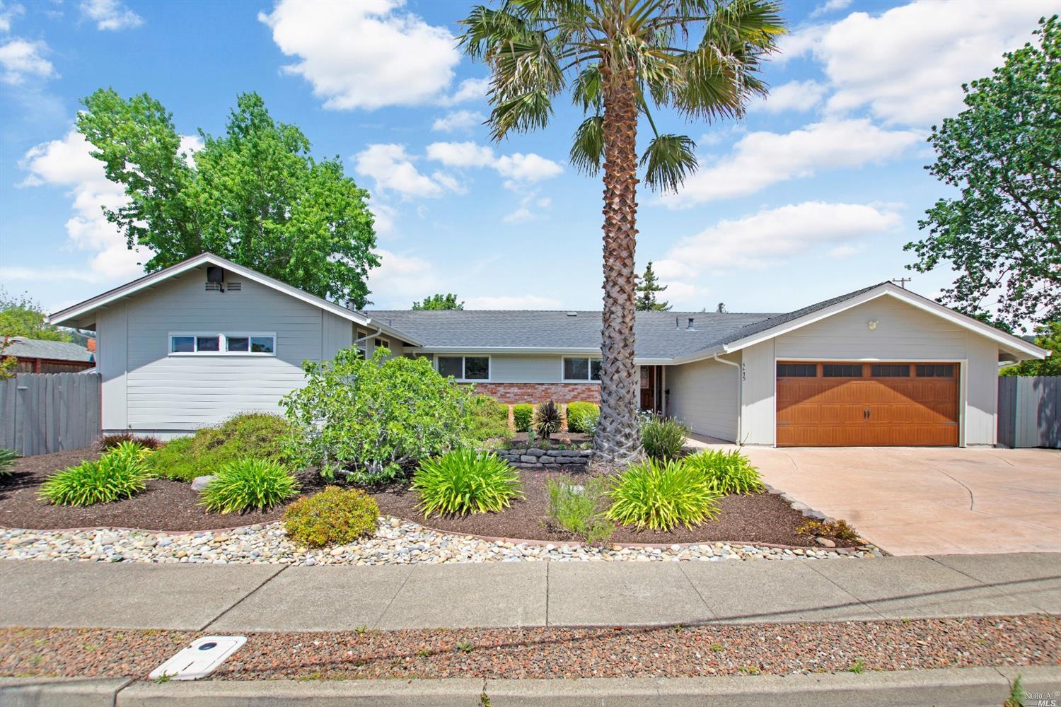 4435 Rinconada Drive Santa Rosa, CA 95409 - Photo 1 of 1 a front view of a house with a yard and a garage