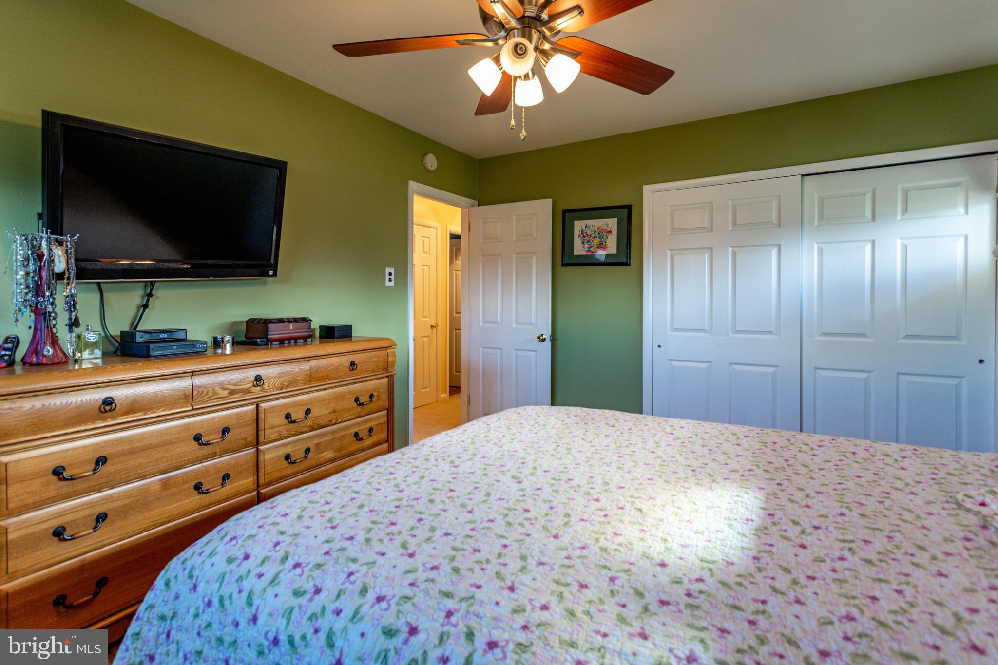 1619 West County Line Road Hatboro, PA 19040 - Photo 19 of 30 a bedroom with a bed and a flat screen tv