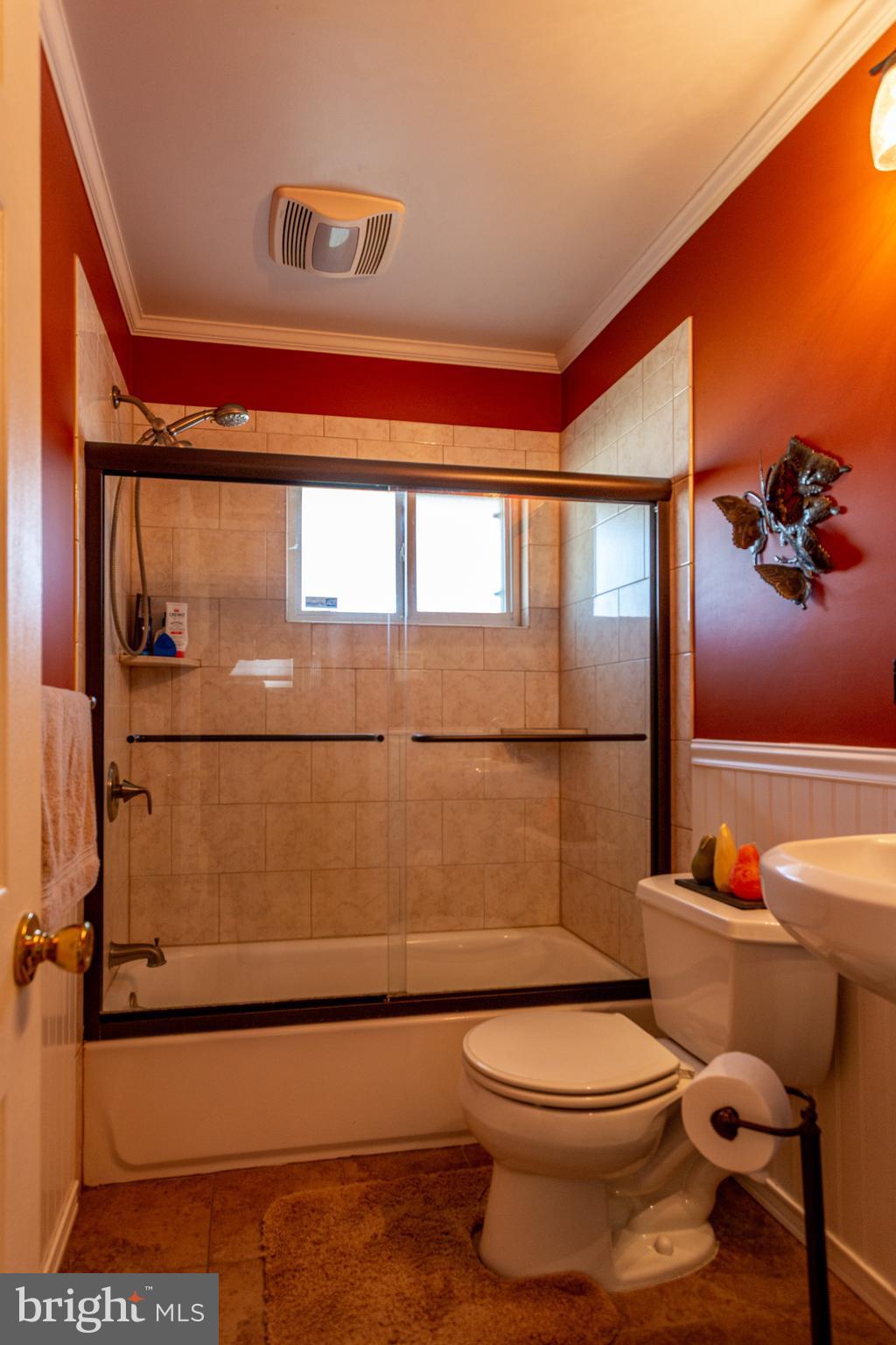 1619 West County Line Road Hatboro, PA 19040 - Photo 20 of 30 a bathroom with a toilet a sink and a large mirror