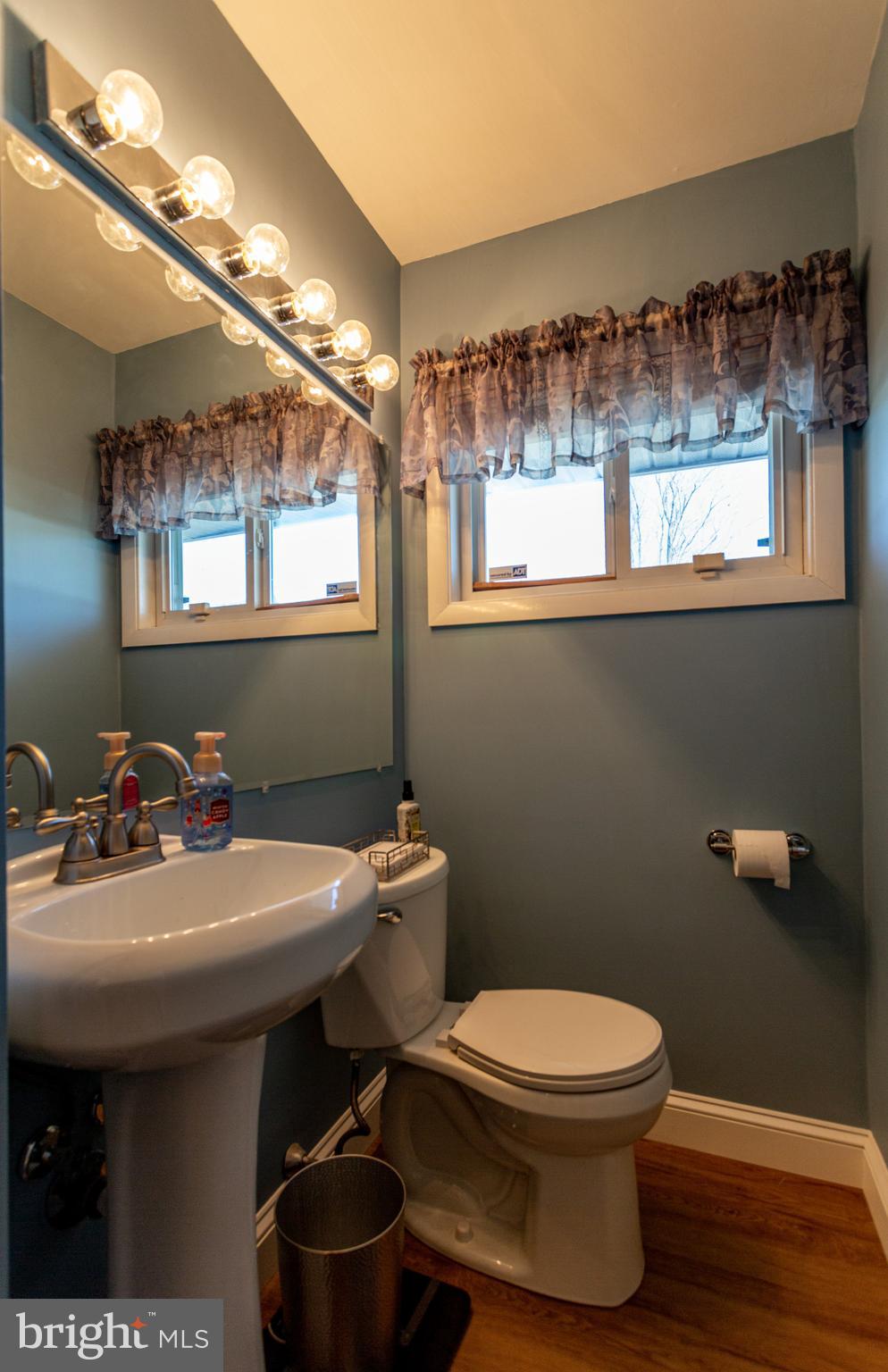 1619 West County Line Road Hatboro, PA 19040 - Photo 22 of 30 a bathroom with a sink a mirror and a toilet