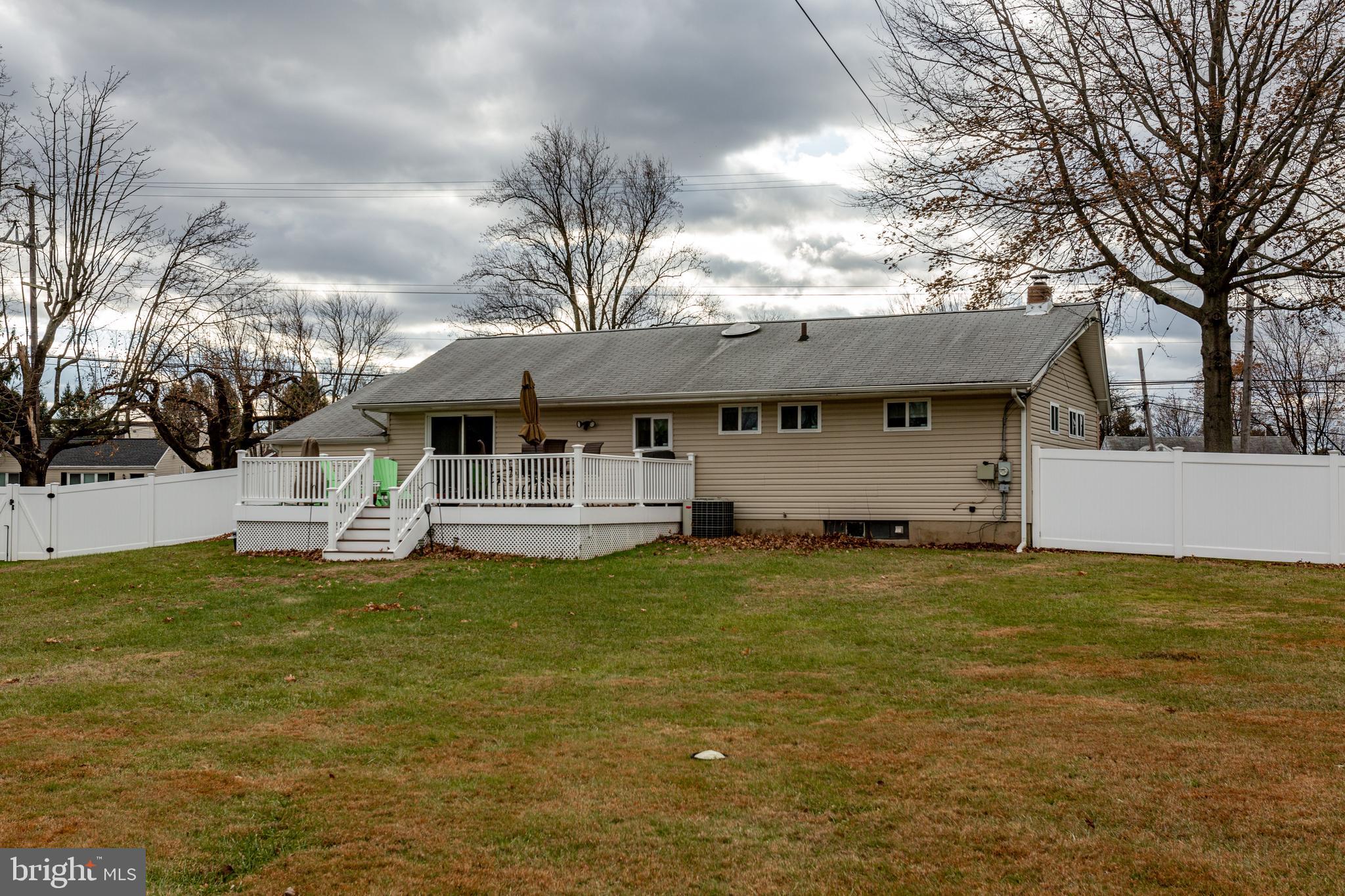 1619 West County Line Road Hatboro, PA 19040 - Photo 25 of 30 a front view of a house with a garden and tree