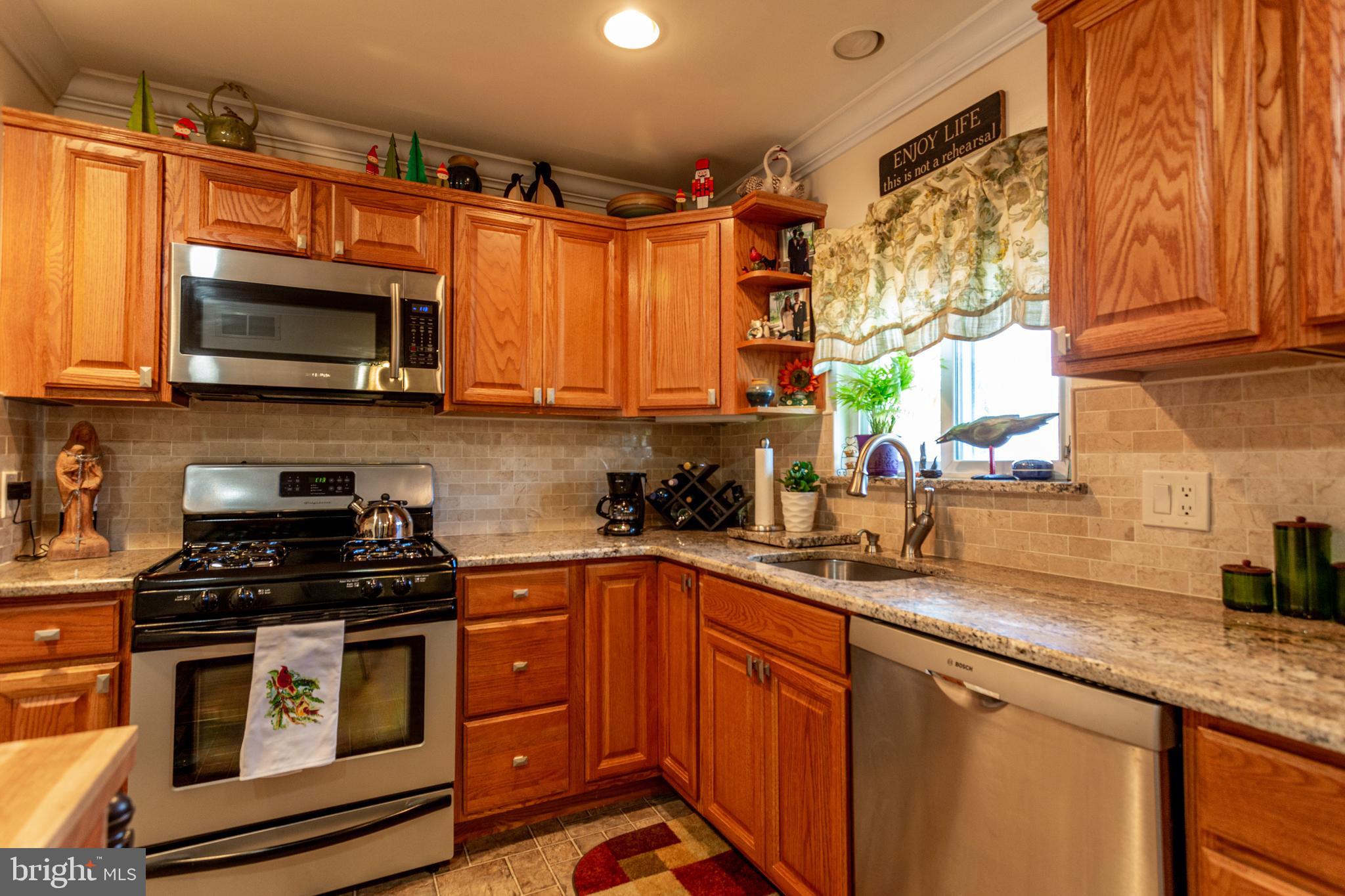 1619 West County Line Road Hatboro, PA 19040 - Photo 7 of 30 a kitchen with stainless steel appliances a stove sink microwave and cabinets
