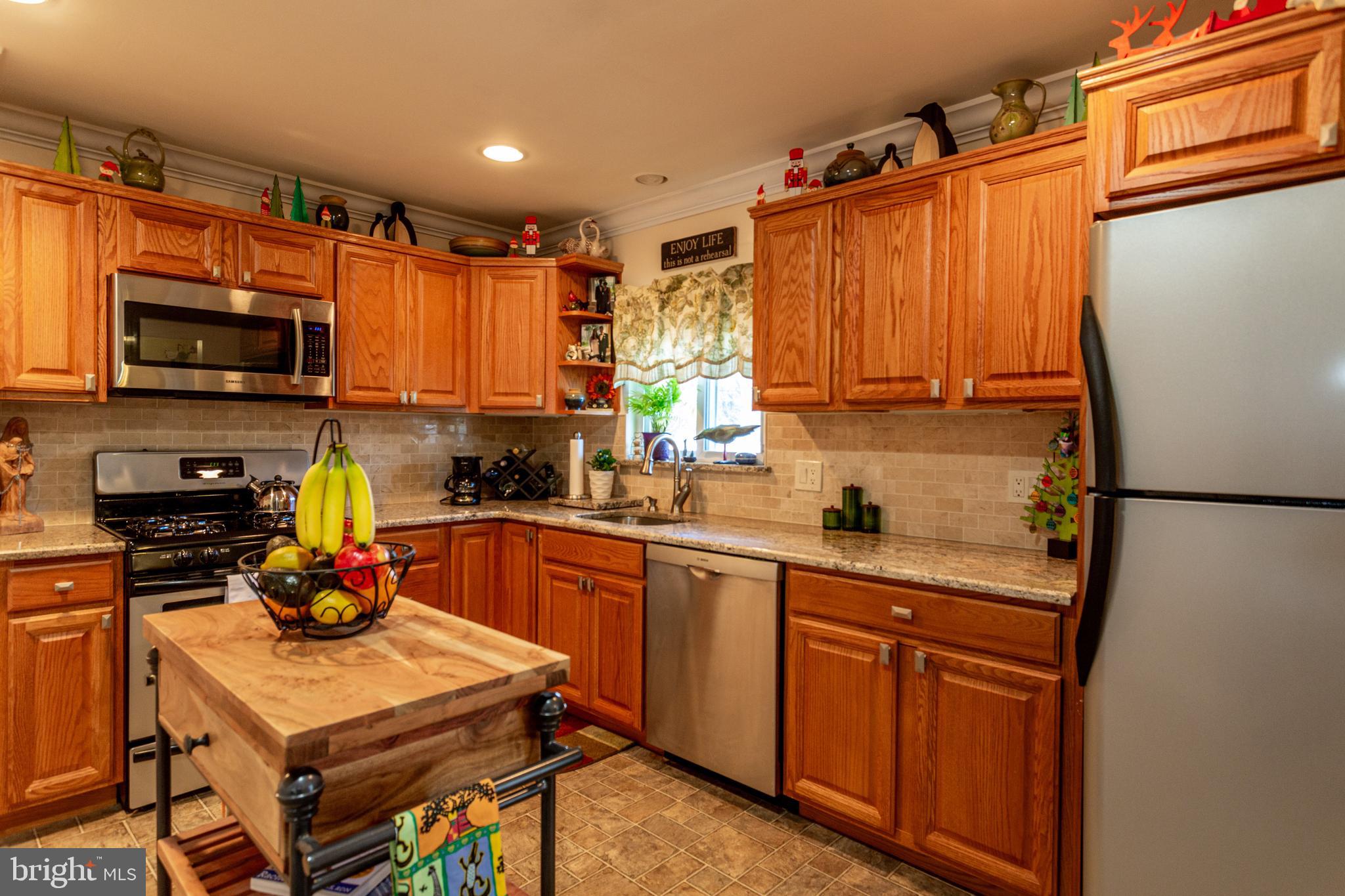 1619 West County Line Road Hatboro, PA 19040 - Photo 10 of 30 a kitchen with stainless steel appliances granite countertop a refrigerator sink stove microwave and cabinets
