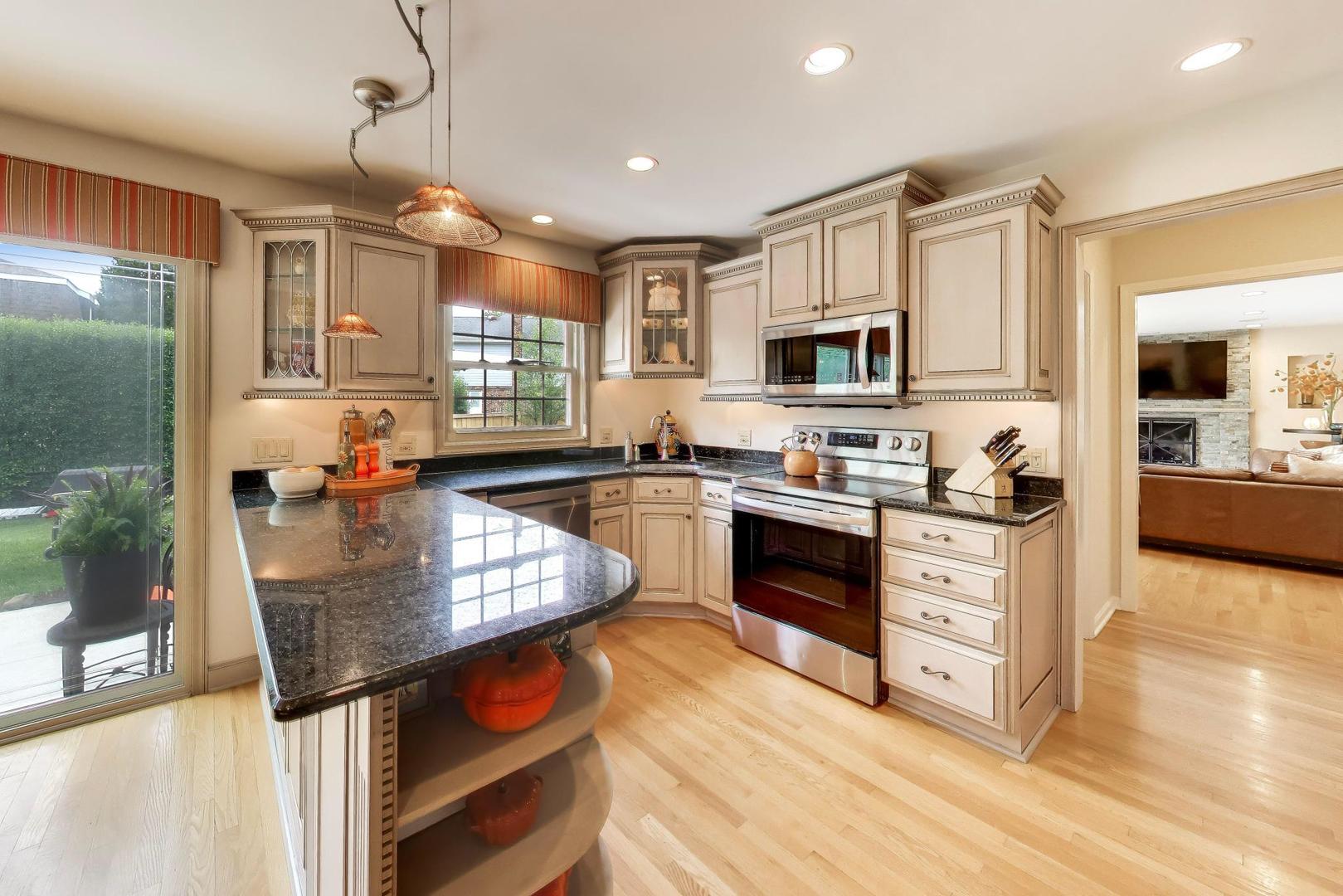 3956 Rutgers Lane Northbrook, IL 60062 - Photo 9 of 41 a kitchen with stainless steel appliances granite countertop a stove refrigerator and cabinets