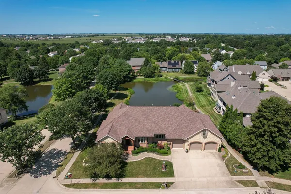 an aerial view of residential houses with outdoor space and river