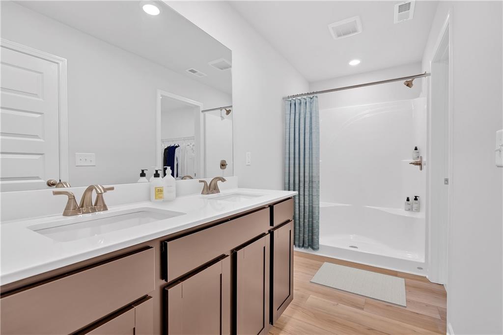 107 Lavender Circle Calhoun, GA 30701 - Photo 18 of 23 a bathroom with a shower sink vanity and mirror