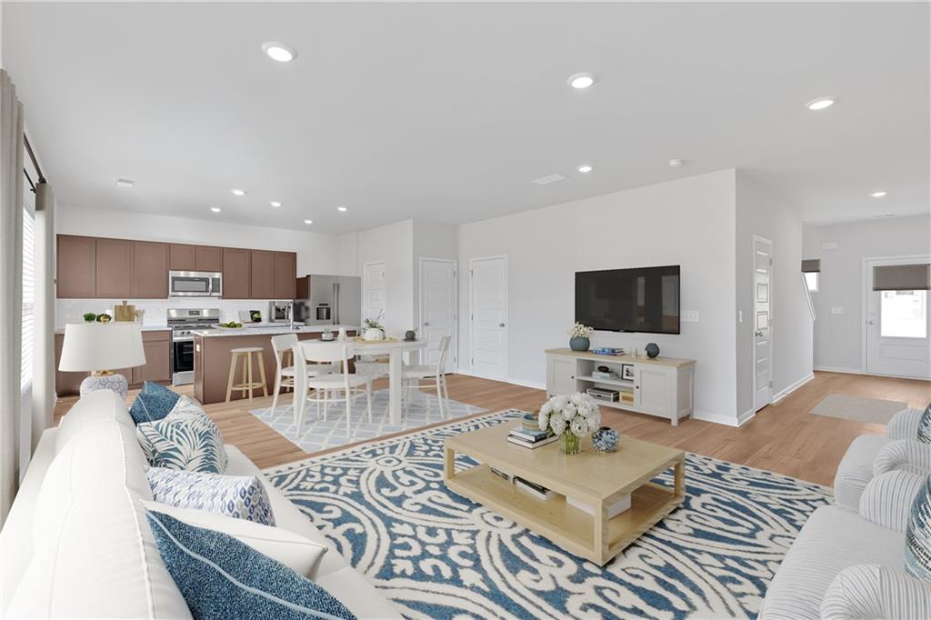 107 Lavender Circle Calhoun, GA 30701 - Photo 5 of 23 a living room with furniture a flat screen tv and kitchen view