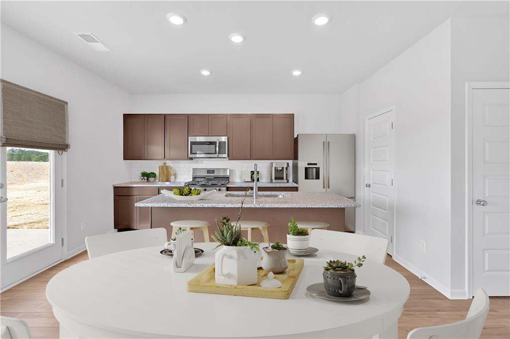 107 Lavender Circle Calhoun, GA 30701 - Photo 7 of 23 a living room with stainless steel appliances a table and chairs