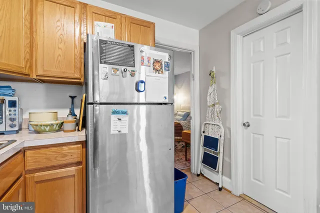 a white refrigerator freezer sitting inside of a kitchen