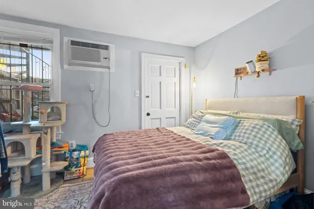 a bedroom with bed and a window