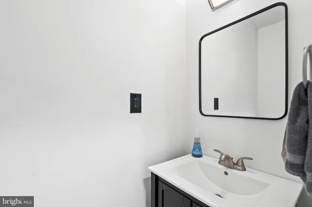 a bathroom with a sink and mirror