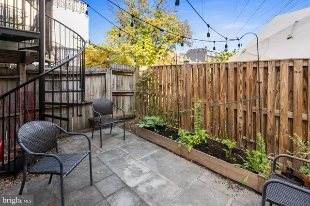 a view of a chairs and table in backyard of the house