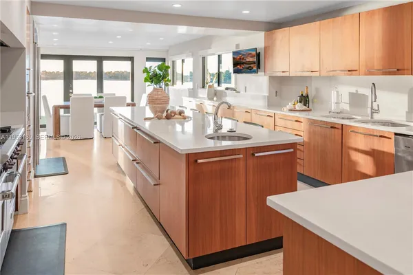a kitchen with stainless steel appliances granite countertop a sink a stove and a refrigerator