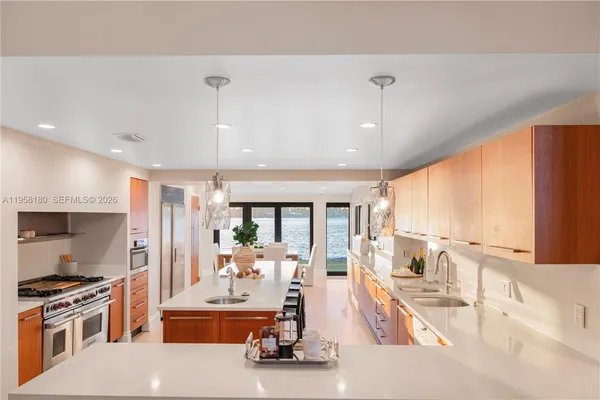 a view of a kitchen with kitchen appliances and a large window