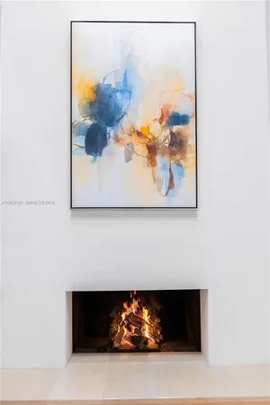 a room with a fireplace and a painting on the wall