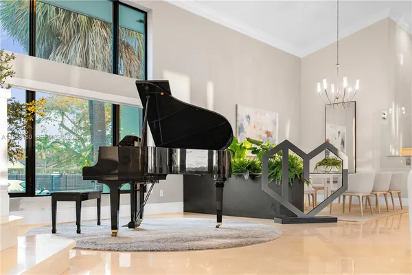 a living room with furniture and a floor to ceiling window