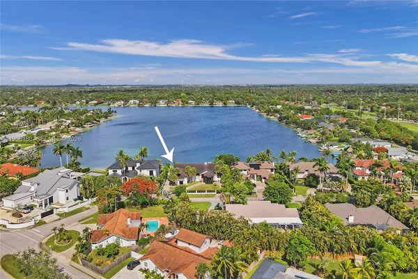 an aerial view of residential building and lake