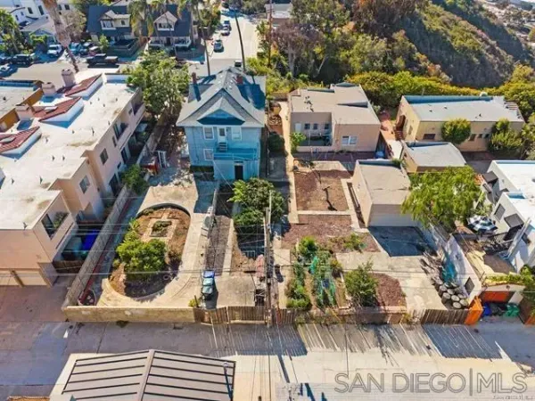 an aerial view of a house with garden space and street view