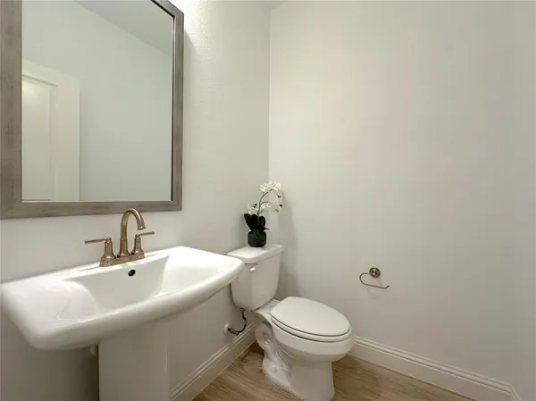 a bathroom with a sink a toilet and mirror