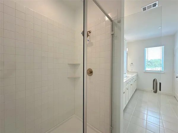 a bathroom with a shower and a sink