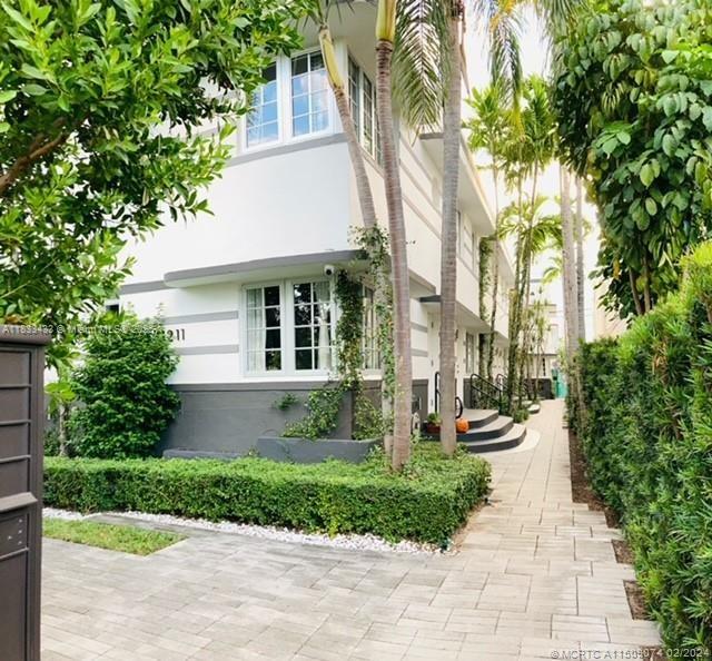 1211 Euclid Avenue, Unit 11 Miami Beach, FL 33139 - Photo 1 of 19 a front view of a house with a yard and trees